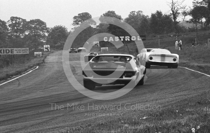 Paul Hawkins, Ford GT40, and Denny Hulme, Lola T70, lead into Island Bend, Oulton Park, Tourist Trophy 1968.
