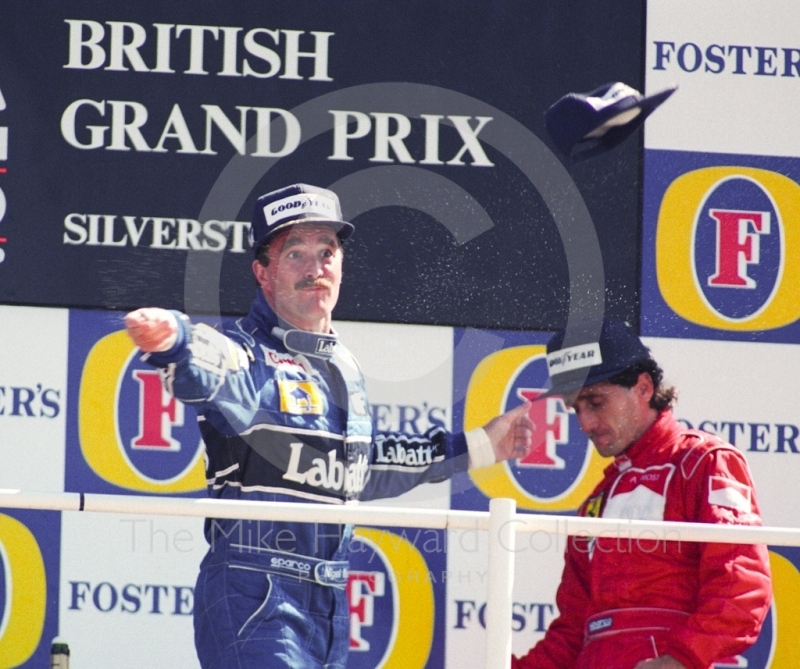 Nigel Mansell, Williams FW14, throws his cap to the crowd after winning the 1991 British Grand Prix at Silverstone.
