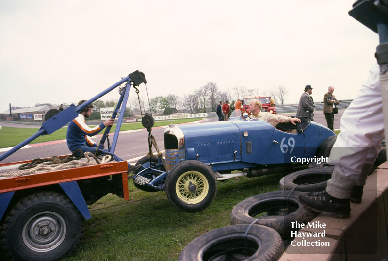 T C Llewellyn's 1929 Bentley being towed away from the chicane, VSCC meeting, Donington Park, May 1979.
