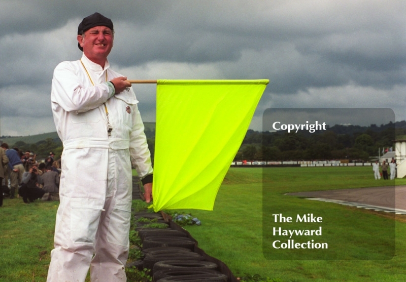 A marshall in period outfit hangs out the yellow flag,Goodwood Revival, 1999