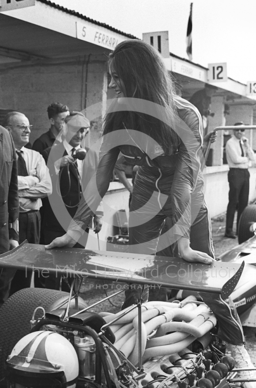 A model poses on the Ferrari 312 V12 of Chris Amon in the pit lane during practice, British Grand Prix, Brands Hatch, 1968
