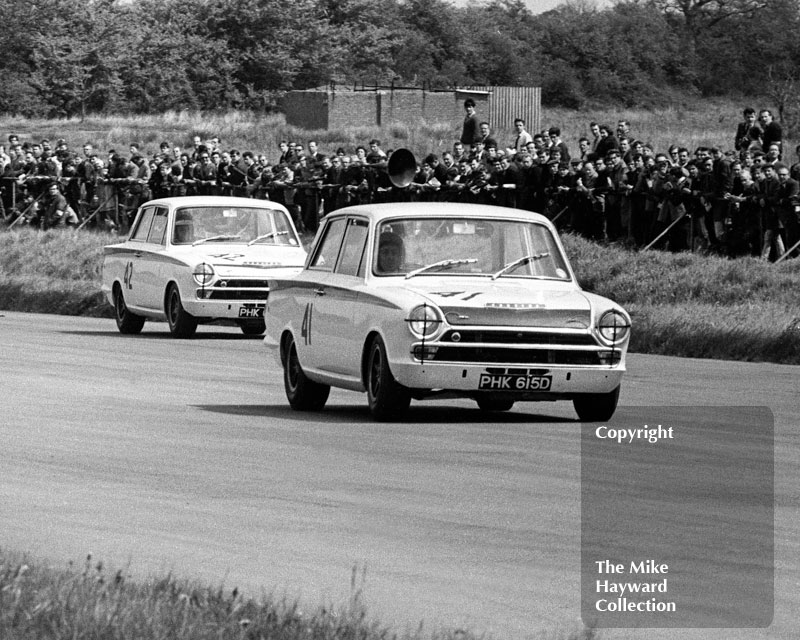 Team mates Peter Arundel, reg no PHK 615D, and Jacky Ickx, Ford Lotus Cortinas, Silverstone International Trophy meeting 1966.

