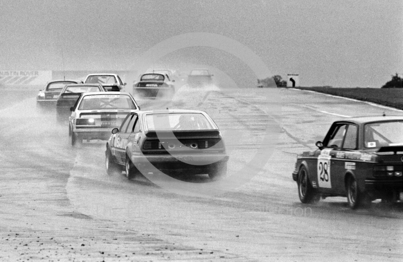 Jean-Marie Pirnay/Patrick Neve, Volvo 240 Turbo, and the field makes its way out of Copse Corner during a thunderstorm, Istel Tourist Trophy, European Touring Car Championship, Silverstone, 1984
