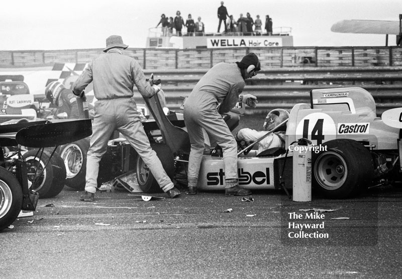 Marshalls help Alberto Colombo after his March 752 BMW was involved in the chicane accident at the Wella European Formula Two Championship, Thruxton, 1975
