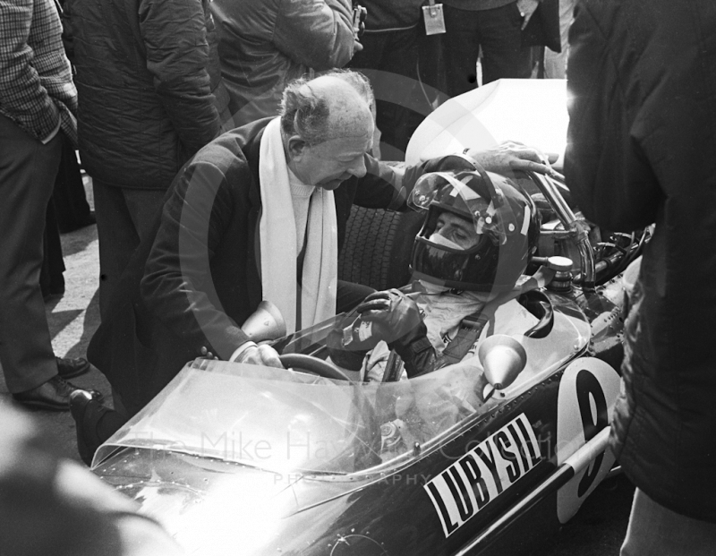 Graham Hill, Brooke Bond Oxo/Rob Walker Lotus 49C, on the grid talking to Raymond Mays before the start of the Race of Champions, Brands Hatch, 1970.
