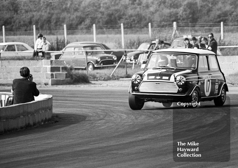 Heading for a photographer is John Rhodes in a Cooper Car Company Mini Cooper S at Becketts Corner, Silverstone Martini International Trophy 1968.
