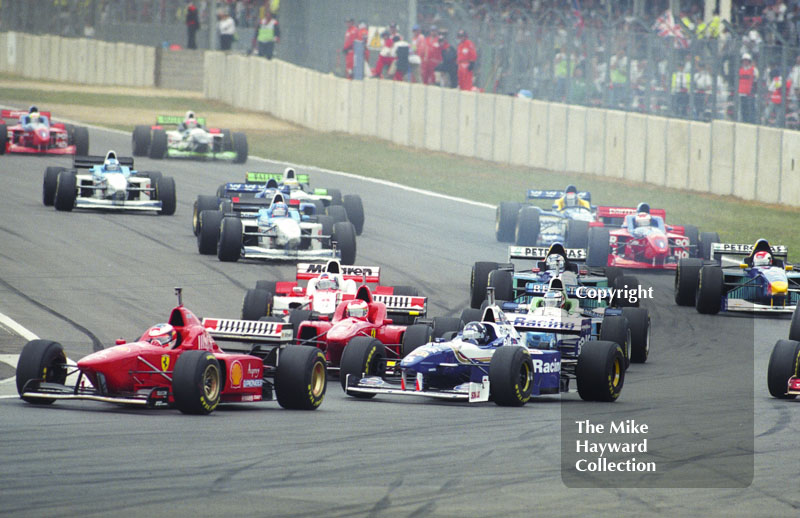 Michael Schumacher, Ferrari F310 ahead of Damon Hill and the pack into Copse Corner, Silverstone, British Grand Prix 1996.
