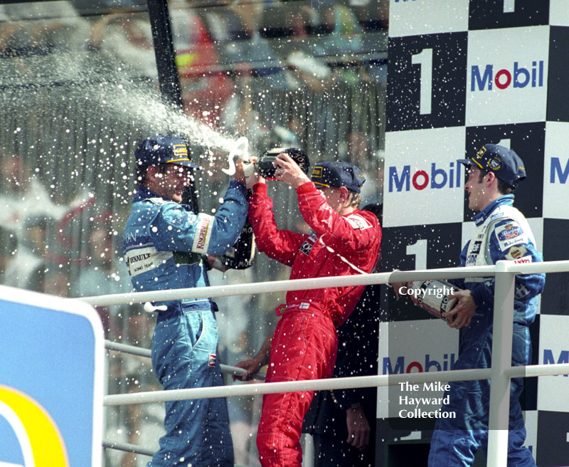 Jacques Villeneuve, Gerhard Berger and Mika Hakkinen on the podium, Silverstone, British Grand Prix 1996.
