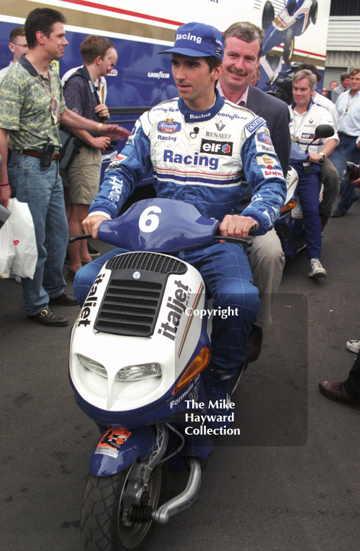 Damon Hill scoots round the paddock, Silverstone, British Grand Prix 1996.
