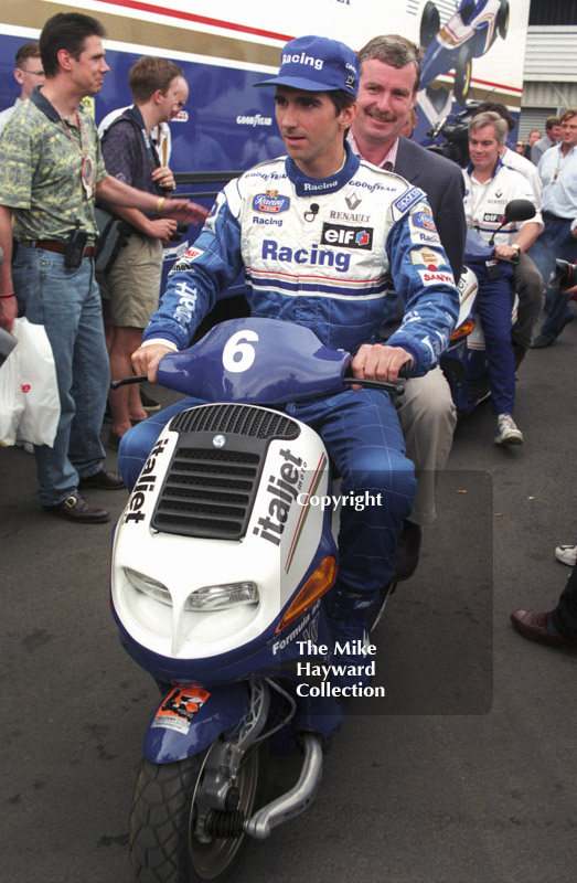 Damon Hill scoots round the paddock, Silverstone, British Grand Prix 1996.
