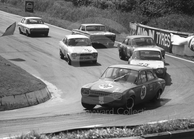 Barry Pearson, Ford Escort, followed by Pat Mannion, Willy Kay and Robert Harris (VOY 673G) (Ford Escorts), Dennis Leech, Ford Falcon Sprint, and Brian Robinson, Lotus Cortina, British Saloon Car Championship race, BRSCC Guards 4,000 Guineas International meeting, Mallory Park, 1969.
