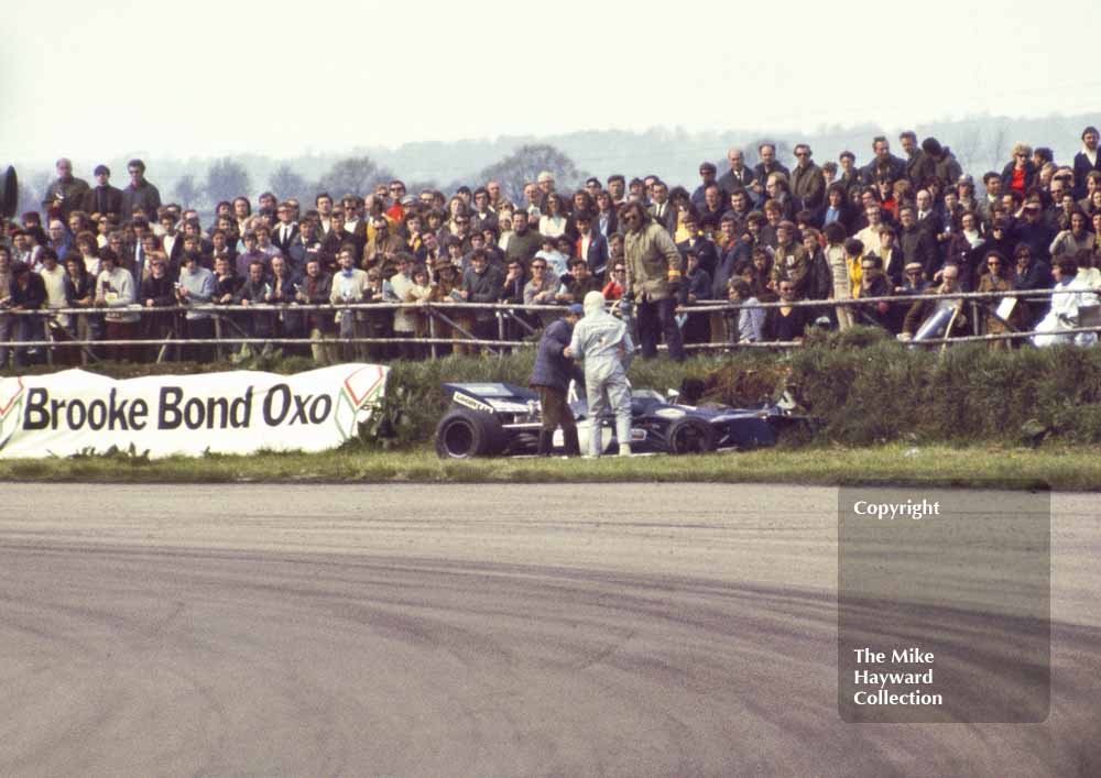 Jackie Stewart, stands by his crashed Tyrrell DFV 003, Silverstone, International Trophy 1971.
