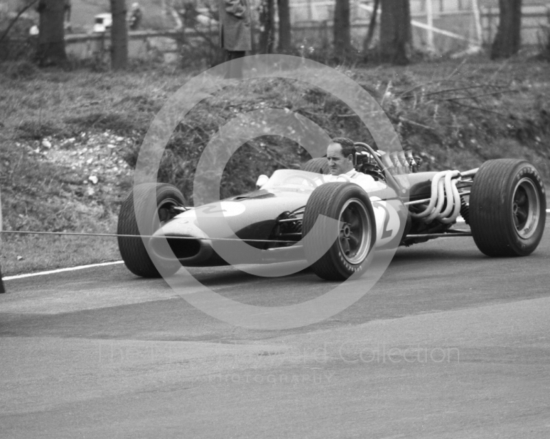 Denny Hulme, Brabham Repco BT20, is towed in after engine failure on lap five of the second heat, Brands Hatch, Race of Champions 1967.
