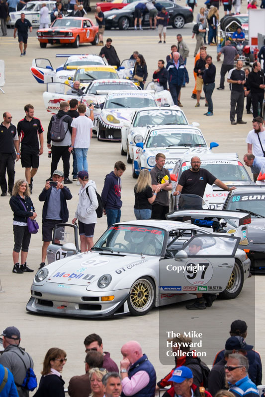 Sports cars lined up in the paddock at the 2016 Silverstone Classic.
