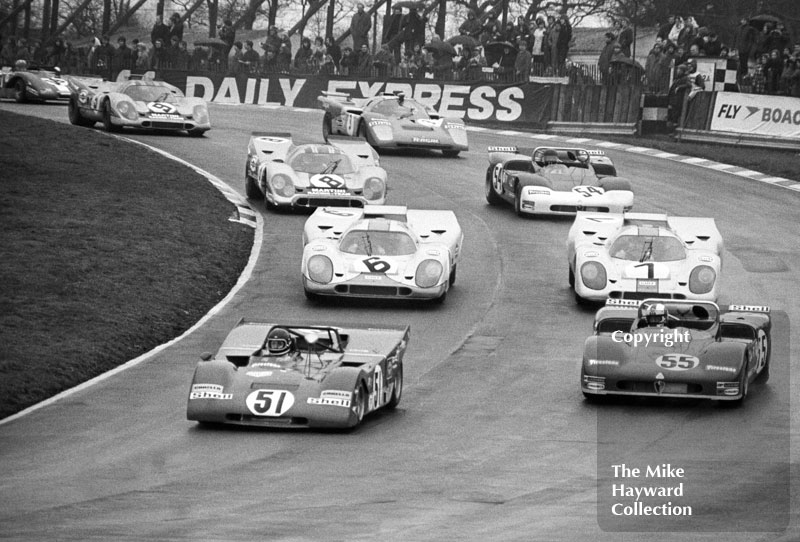 Jacky Ickx, Ferrari 312P, leads through Paddock Bend on the first lap, followed by Rolf Stommelen/Toine Hezemans, Autodelta Alfa Romeo T71, and Jo Siffert/Derek Bell and Pedro Rodriguez/Jackie Oliver, JW Porsche 917K, Brands Hatch, BOAC 1000k 1971.
