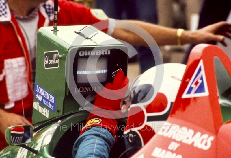 Teo Fabi, Benetton B187, checks lap times in the pits, British Grand Prix, Silverstone, 1987
