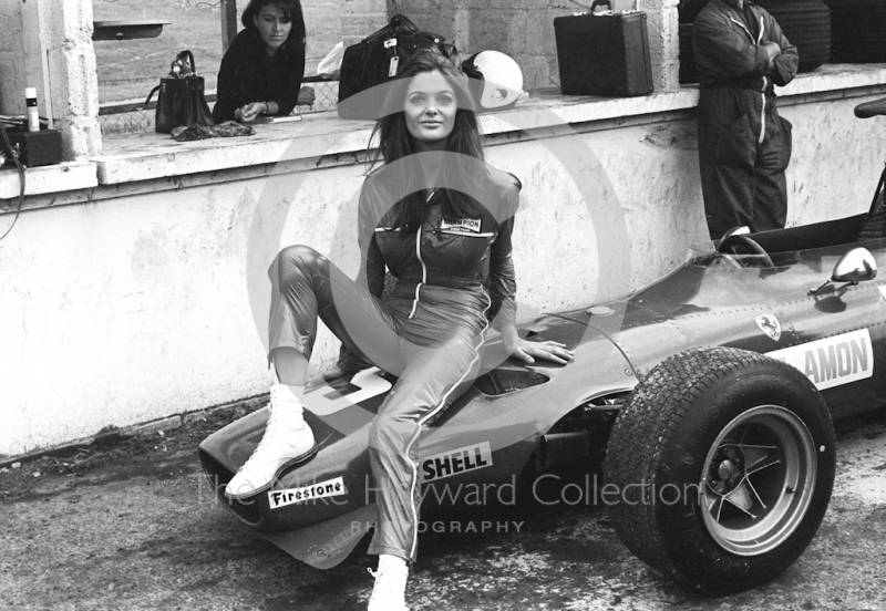 A model poses on the Ferrari V12 312 0011&nbsp;of Chris Amon in the pit lane during practice, British Grand Prix, Brands Hatch, 1968.
