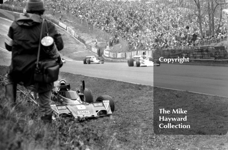 James Hunt, Marlboro McLaren M23 and Niki Lauda, Ferrari 312T/2, pass Carlos Pace's abandoned Brabham Alfa Romeo BT45, Race of Champions, Brands Hatch, 1976.
