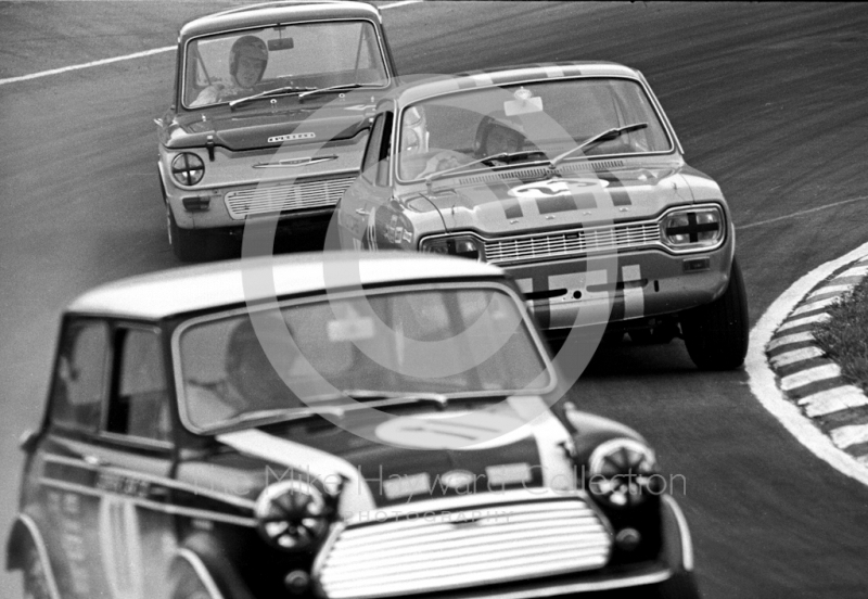 John Rhodes, Mini Cooper S, Alan Peer, Dagenham Motors Ford Escort GT, and Tony Lanfranchi, Alan Fraser Sunbeam Imp,&nbsp;at South Bank Bend, Brands Hatch, Grand Prix meeting 1968.
