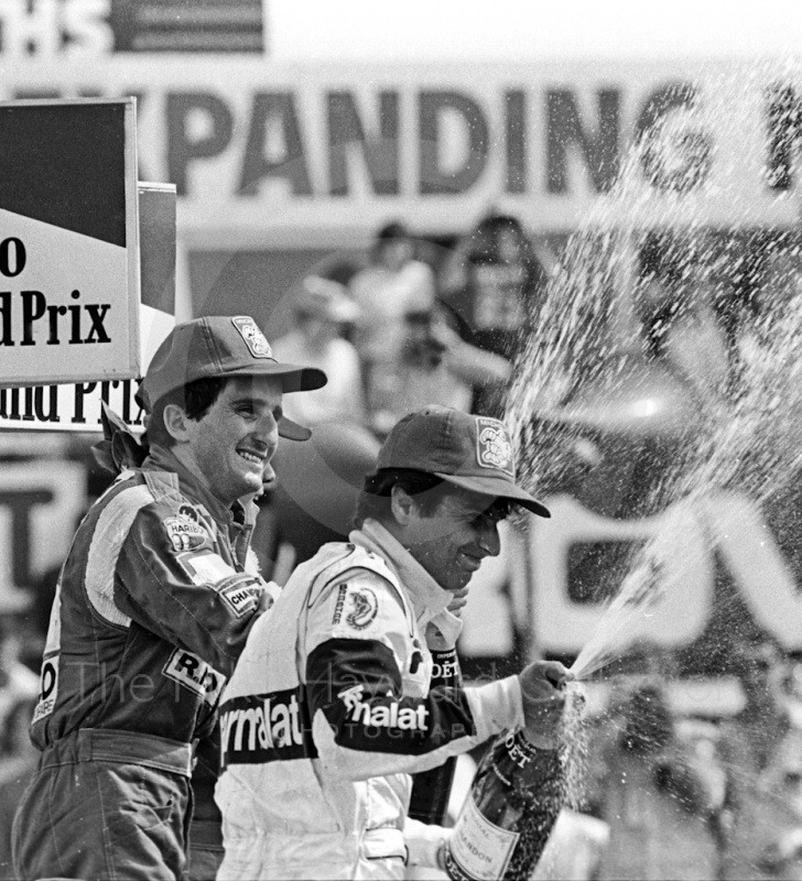 Winner Alain Prost, Renault RE40, and second placed Nelson Piquet, Brabham BT52B, on the podium, British Grand Prix, Silverstone, 1983
