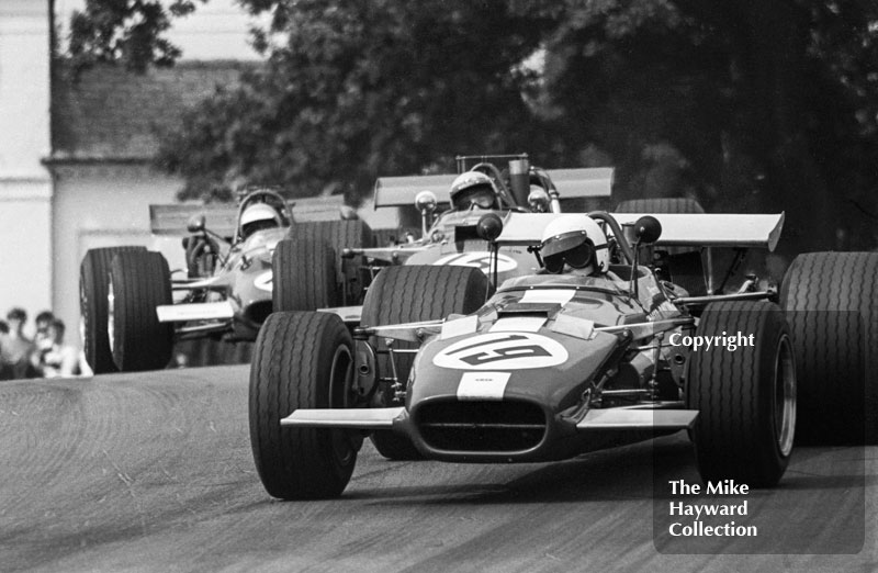 Keith Holland, Alan Fraser F5000 Lola T142, followed by Mike Walker, Alan McKechnie F5000 Lola T142, and Trevor Taylor, Surtees TS5, at Lodge Corner, Oulton Park Gold Cup 1969.
