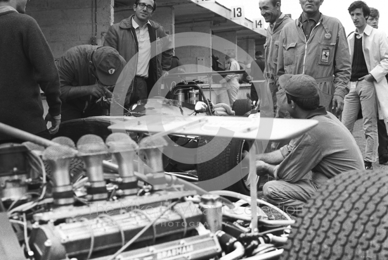 Activity in the Brabham and Ferrari pits during practice for the 1968 British Grand Prix at Brands Hatch.
