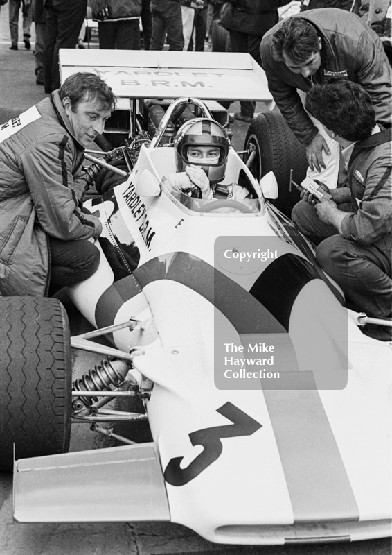 Pedro Rodriguez, Yardley BRM 160, chats to race technician Gerry Van der Weyden, left, on the grid before the Oulton Park Rothmans International Trophy, 1971.