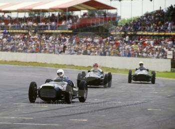 A trio of V16 BRMs howl through Woodcote during a demonstration, British Grand Prix, Silverstone, 1987
