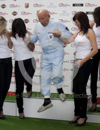 Sir Stirling Moss gets a helping hand from BSM girls, Silverstone Classic 2010