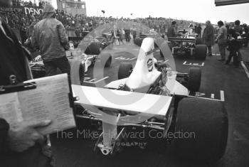 Jochen Mass, McLaren M23, and Emerson Fittipaldi, McLaren M23, on the grid, Brands Hatch, Race of Champions 1975.
