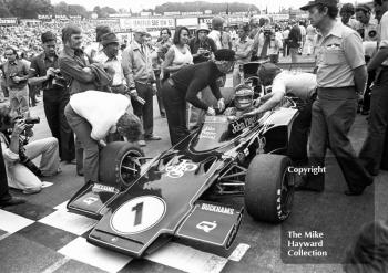 Ronnie Peterson, JPS Lotus 72E, with Colin Chapman on the grid before the start of the 1974 British Grand Prix at Brands Hatch.
