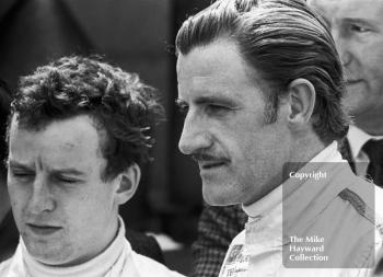 Gold Leaf Team Lotus team mates Jack Oliver, left, and Graham Hill in the paddock at Brands Hatch, 1968 British Grand Prix.
