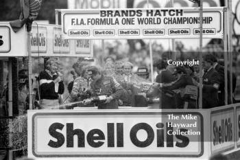 Nigel Mansell, Ayrton Senna Keke Rosberg celebrate on the podium, Brands Hatch, 1985 European Grand Prix. Alain Prost is also on the podium as he won the championship by finishing fourth at this race.
