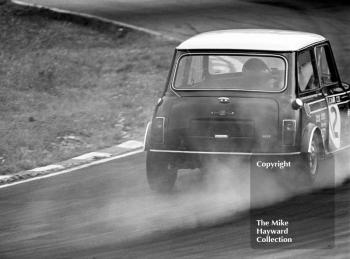 Steve Neal, Cooper Car Company Mini Cooper S, smokes around South Bank Bend, ritish Saloon Car Championship race, 1968 Grand Prix meeting, Brands Hatch.
