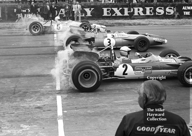 Jochen Rindt, Gold Leaf Team Lotus 49B; Jackie Stewart, Matra MS80; and Denny Hulme, McLaren M7A, Silverstone, 1969 British Grand Prix.
