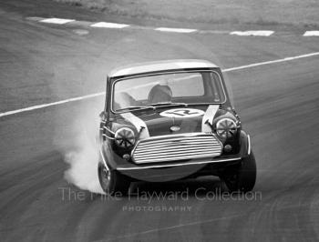 Steve Neal, Cooper Car Company Mini Cooper S, smokes through South Bank Bend, Brands Hatch, Grand Prix meeting 1968.
