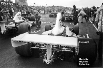 Jochen Mass, McLaren M23, and Emerson Fittipaldi, McLaren M23, on the grid, Brands Hatch, Race of Champions 1975.
