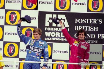 Thierry Boutsen and race winner Alain Prost on the podium at Silverstone, 1990 British Grand Prix.
