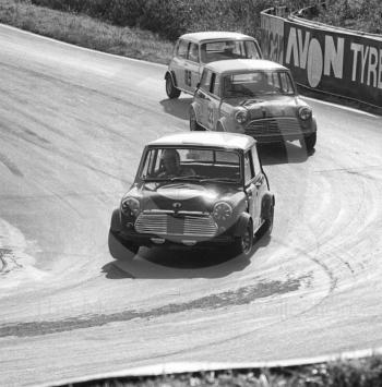 John Handley, British Leyland Mini Cooper S, followed by Roger Enever, JCB Mini Cooper S, and Brian Chatfield, Mini Cooper S, Shaw's Hairpin, British Saloon Car Championship race, BRSCC Guards 4,000 Guineas International meeting, Mallory Park, 1969.
