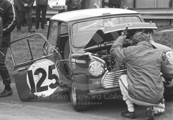 John Rhodes inspects his battered British Leyland Mini Cooper S, Brands Hatch, Race of Champions meeting 1969.
