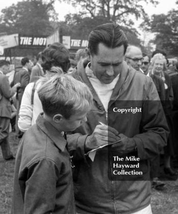 Jack Brabham signs autographs in the paddock, Oulton Park Gold Cup 1962.
