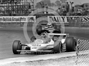 Jacques Laffite, Ligier JS11, followed by Keke Rosberg, Wolf WR7, at Copse Corner, Silverstone, British Grand Prix 1979.
