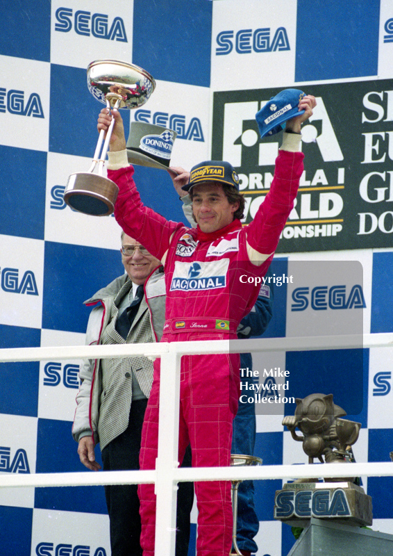 Race winner Ayrton Senna acknowledges the fans watched by circuit owner Tom Wheatcroft, Donington Park, European Grand Prix 1993.