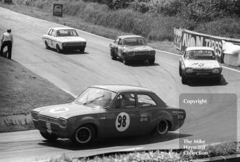 Barry Pearson, Ford Escort, followed by Pat Mannion (PJN 232G) and Willy Kay (Ford Escorts), and Brian Robinson, Lotus Cortina, British Saloon Car Championship race, BRSCC Guards 4,000 Guineas International meeting, Mallory Park, 1969.
