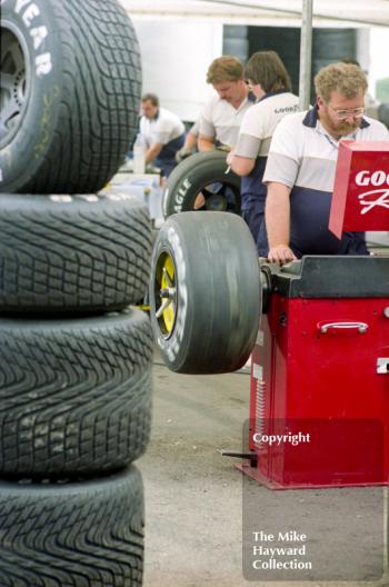 Goodyear technicians at work balancing tyres in the paddock, Silverstone, 1992 British Grand Prix.
