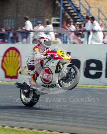 Kevin Schwantz pops a wheelie on his Team Lucky Strike Suzuki, Donington Park, British Grand Prix 1991.