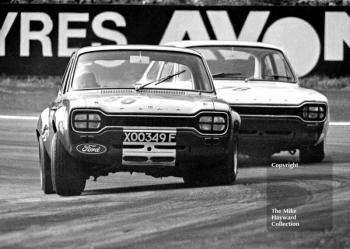 Frank Gardner, Alan Mann Ford Escort, reg no XOO 349F, and Mike Crabtree, John Willment Ford Escort, Oulton Park, Gold Cup meeting 1969.
