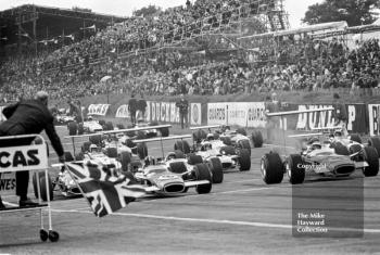 The Gold Leaf Team Lotus 49s of Graham Hill and Jack Oliver lead off the grid at the 1968 British Grand Prix, held at Brands Hatch.
