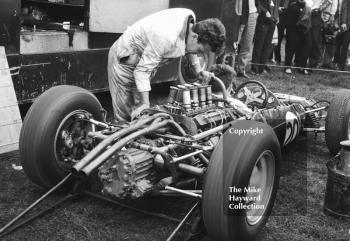 Jo Bonnier's Rob Walker Cooper Climax being warmed up in the paddock by mechanic Tom Cleverley at the Oulton Park Gold Cup 1963.
