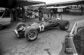 Race technician Gerry Van der Weyden drives Pedro Rodriguez's BRM P133 V12 through the paddock, Brands Hatch, 1969 Race of Champions.